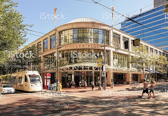 018 - Portland, OR, USA - September 8, 2013: A street view of Pioneer Place with people crossing the street.